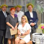Zbigniew Czerkas - wicestarosta Powiatu Sokołowskiego, Daniel Krakowski – przewodniczący Rady Miasta Sokołów Podlaski, Damian Wołyniec – kapelmistrz orkiestry dętej Ochotniczej Straży Pożarnej oraz Hanna Lecyk – radna Rady Miasta Sokołów Podlaski, wieloletnia Dyrektor Miejskiej Biblioteki Publicznej, Katarzyna Nazarczuk – Menadżer ds. Rozwoju Finansowania Małych i Średnich Przedsiębiorstw Banku Santander, Prezes Fundacji „Pozytywna Przedsiębiorczość” pozują do wspólnego zdjęcia. Panowie z żółtymi wiankami na głowach.